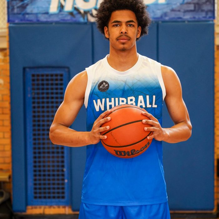 Basketball player holding a basketball court in the court